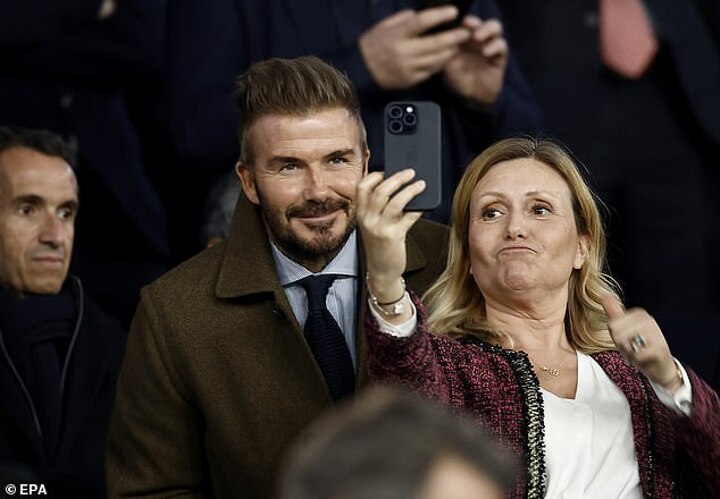 David Beckham poses for photos with fans as he watches PSG take on Liverpool