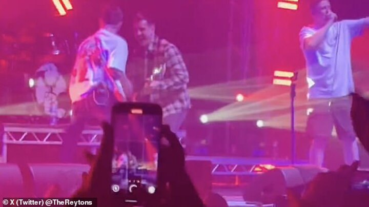 Gary Neville plays bass in surprise appearance live on stage at Manchester gig